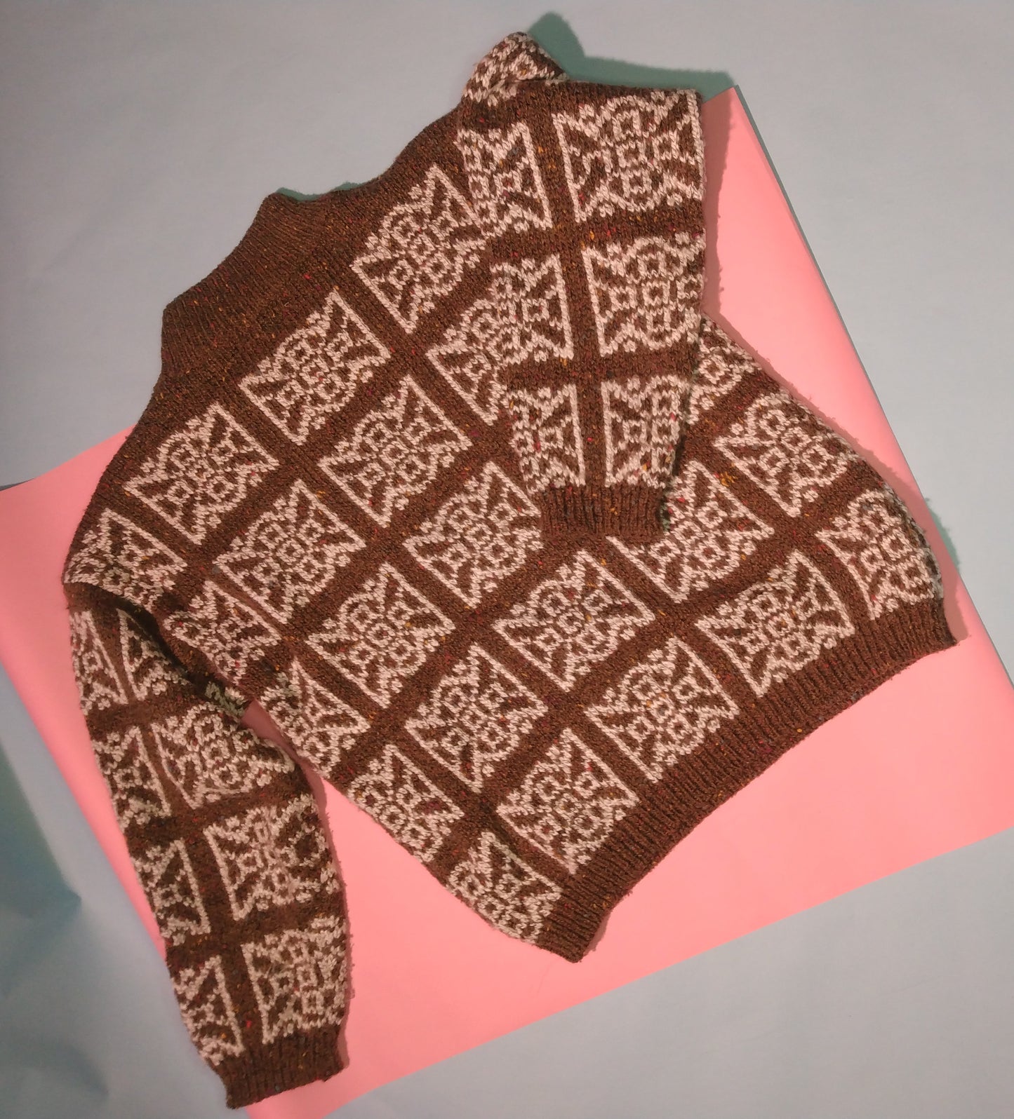 Brown flecked sweater with white geometric pattern